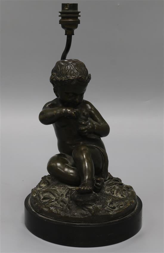 A late 19th century French bronze of a putto and dove, converted to a lamp height 33cm